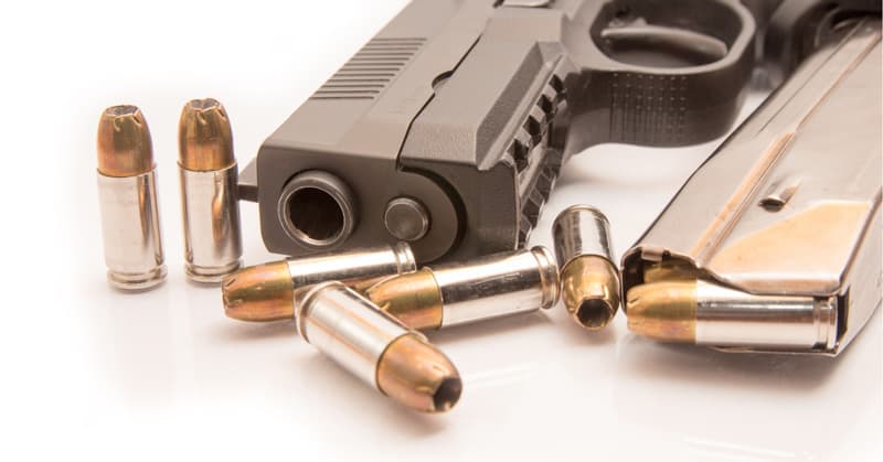 close-up photo of 9mm ammo, magazine and pistol