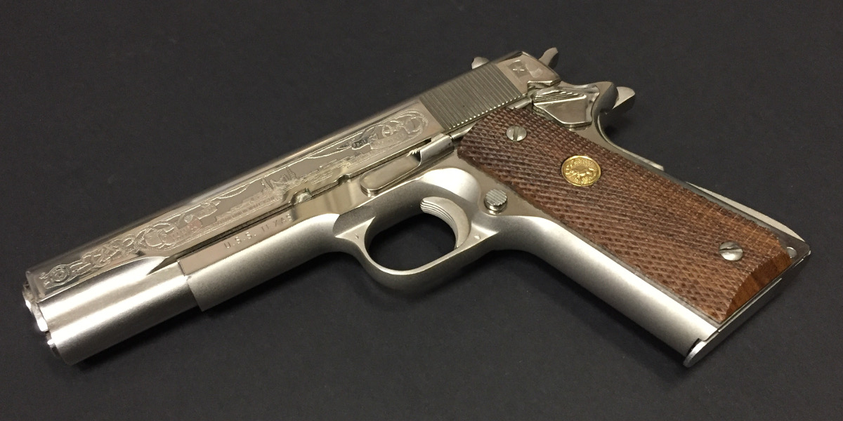 photo of a pistol with engraving on its slide