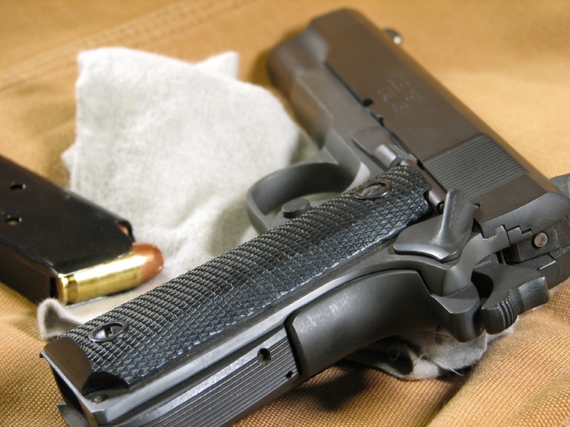 close-up photo of a 1911 pistol and its magazine