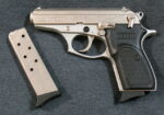 nickel 380 pistol and an extra magazine